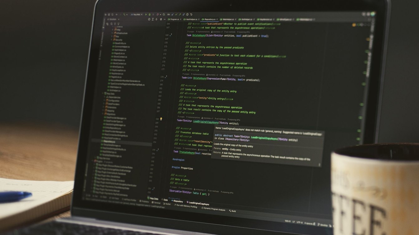 A laptop on a desk showing a terminal with a red API error line
